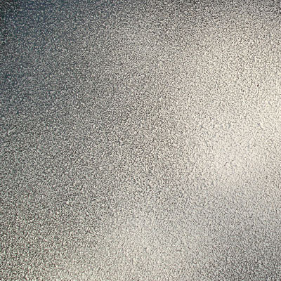 Light dusting of snow spray on glass